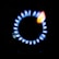 A stove burner with a ring of blue flames surrounding a central black disc, with a hint of orange flame visible at one spot.