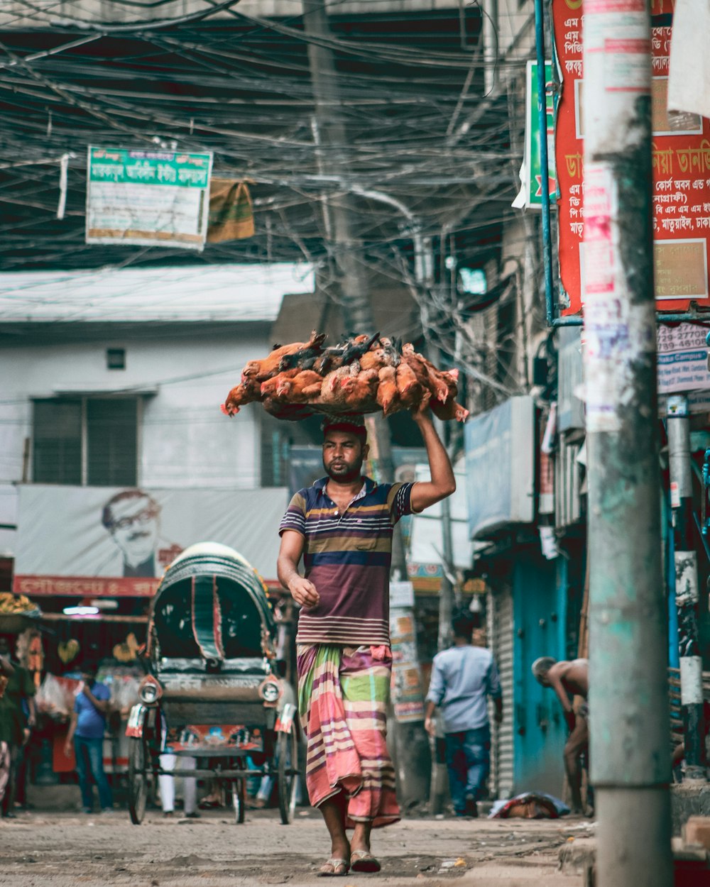 man in black tank top and pink pants standing on street during daytime