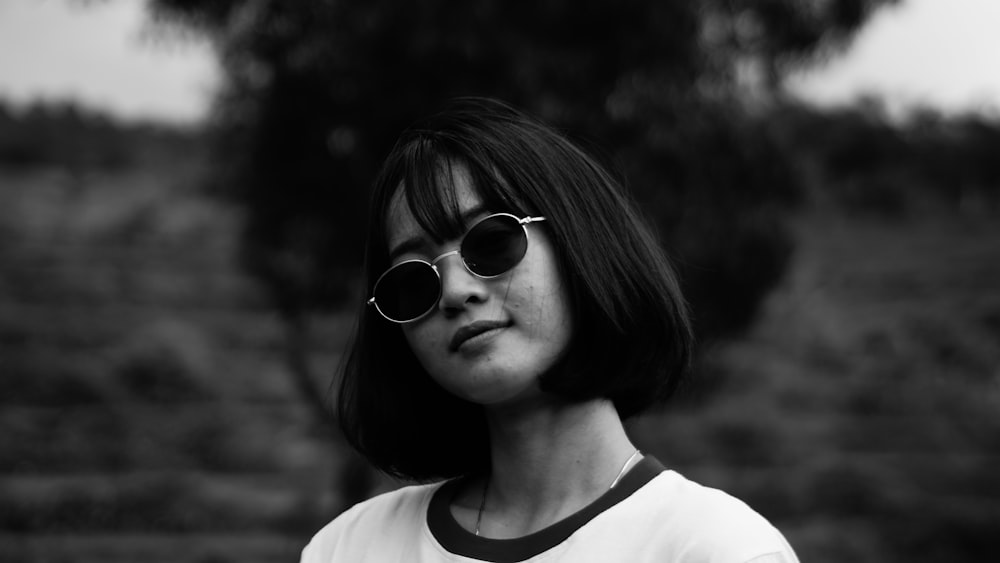 woman in white crew neck shirt wearing black sunglasses