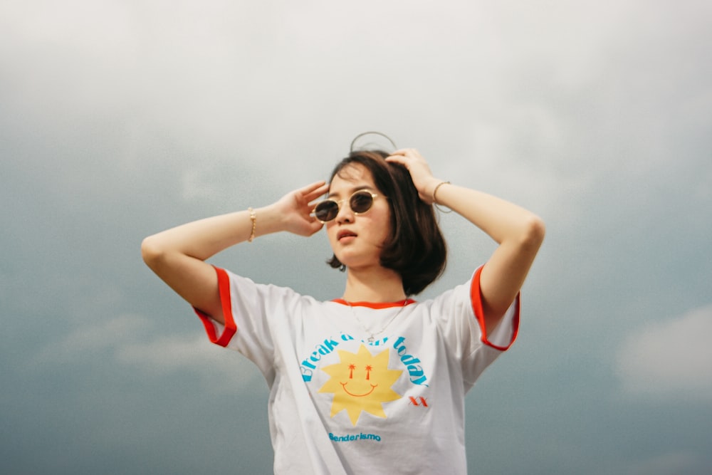 woman in white and red crew neck t-shirt wearing black sunglasses