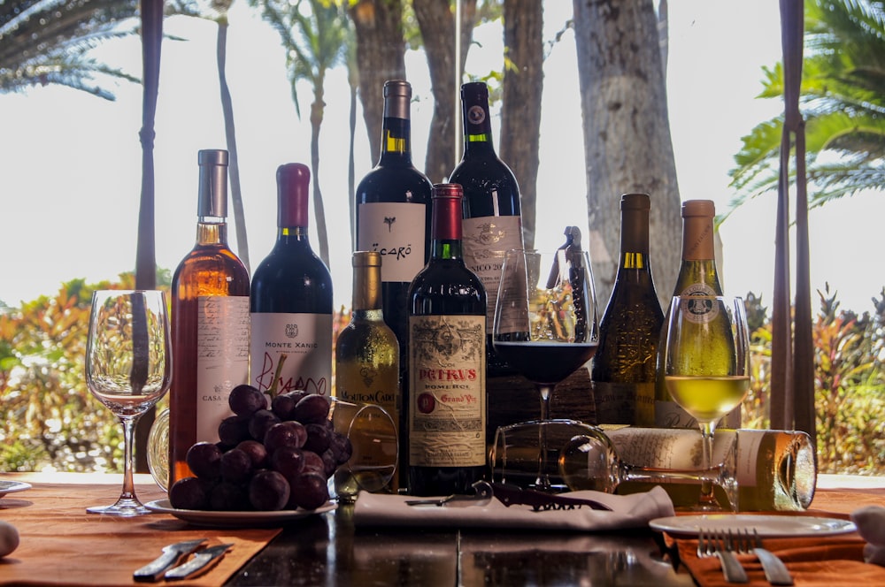 wine bottles on brown wooden table