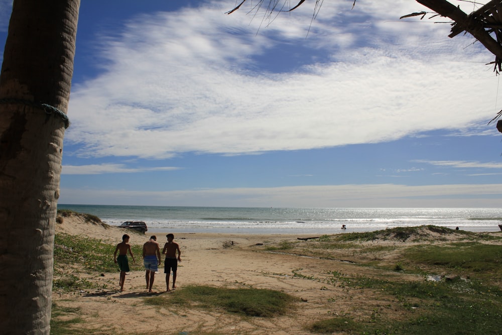 2 person walking on beach during daytime