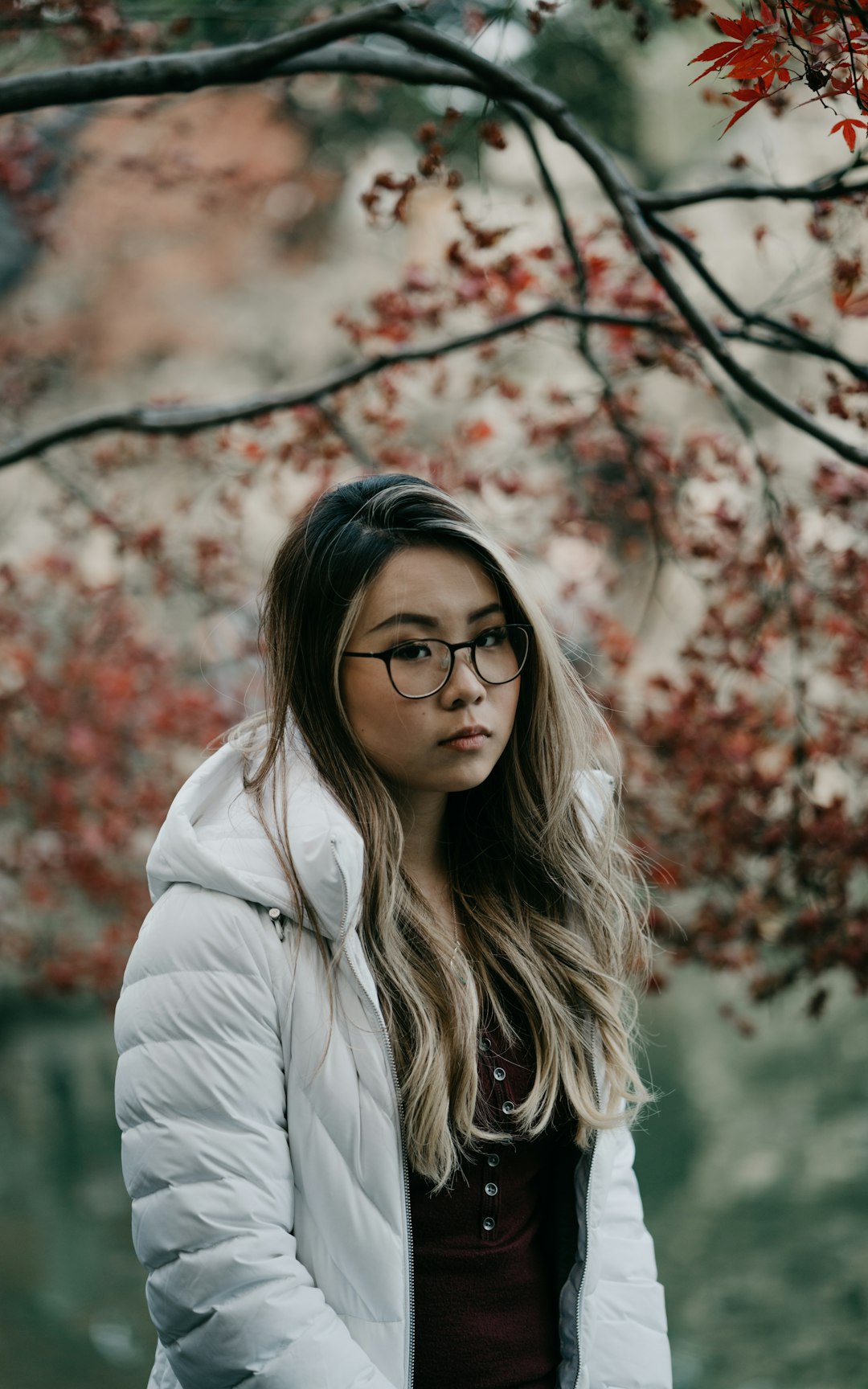 woman in white jacket wearing black framed eyeglasses