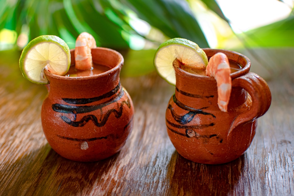 2 brown ceramic jars on brown wooden table