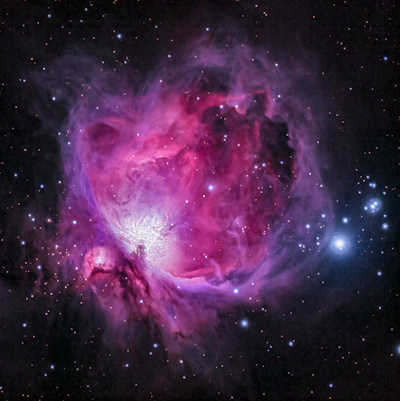 orion nebula photograph in pink purple