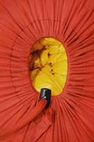 A vibrant satin return gift bag with a shiny finish and elegant drawstring closure.