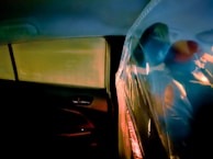 Interior shot showing steam sanitation being applied to leather seats inside a car.