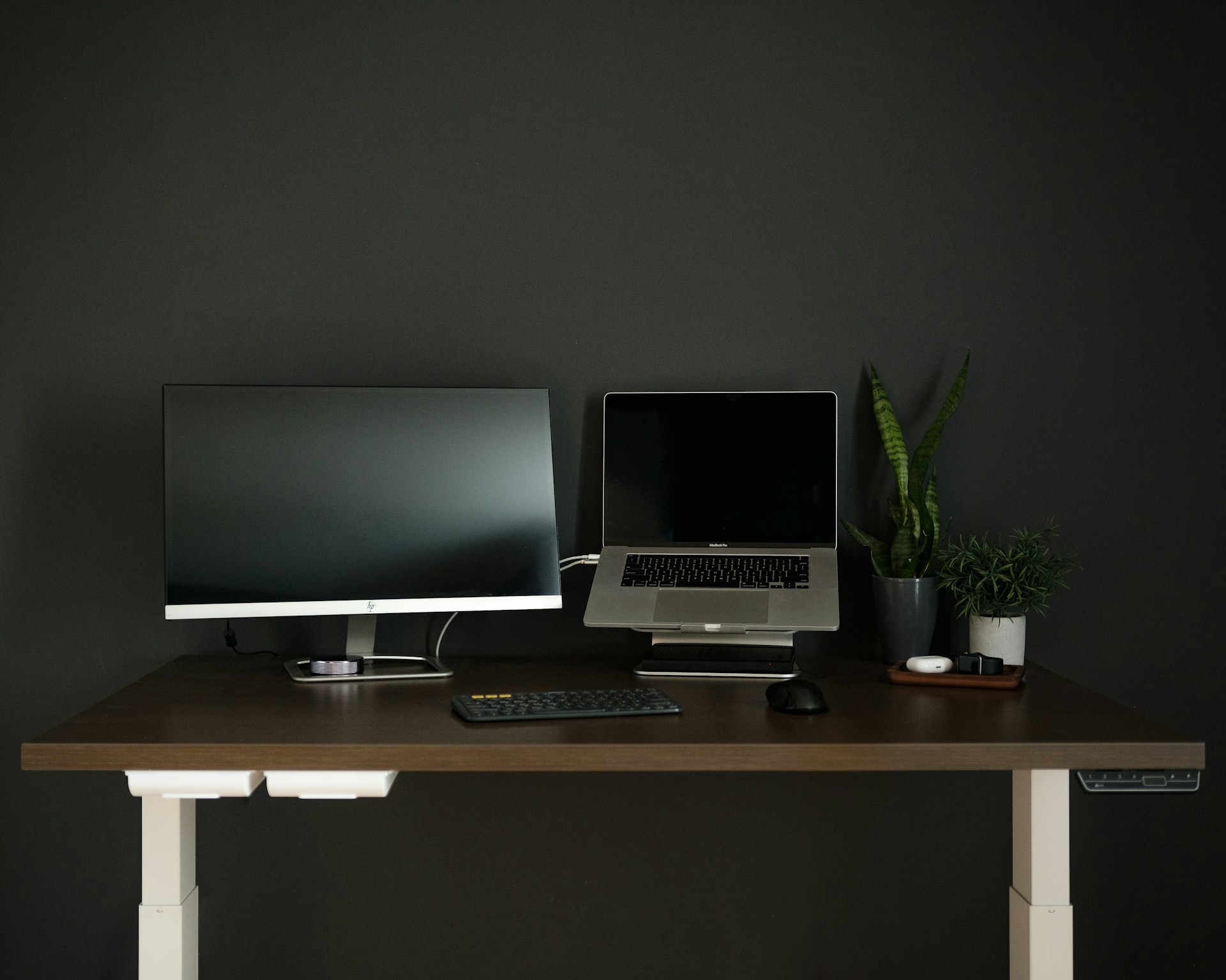 silver flat screen computer monitor on brown wooden desk