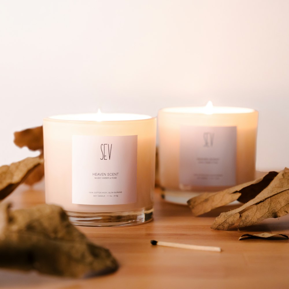 a couple of candles sitting on top of a wooden table