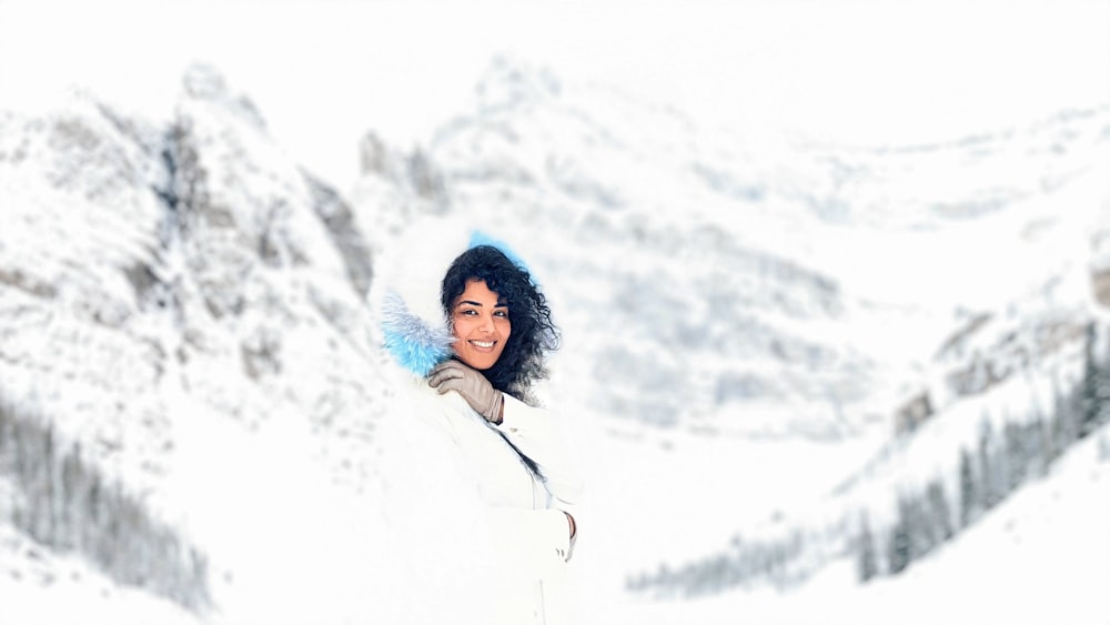 woman in black jacket standing on snow covered ground during daytime