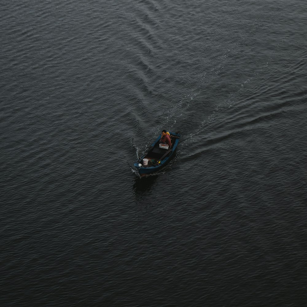 2 people riding on kayak on body of water during daytime