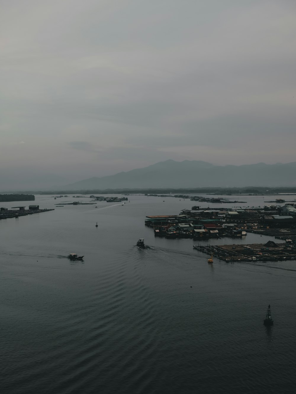 boat on sea under gray sky during daytime