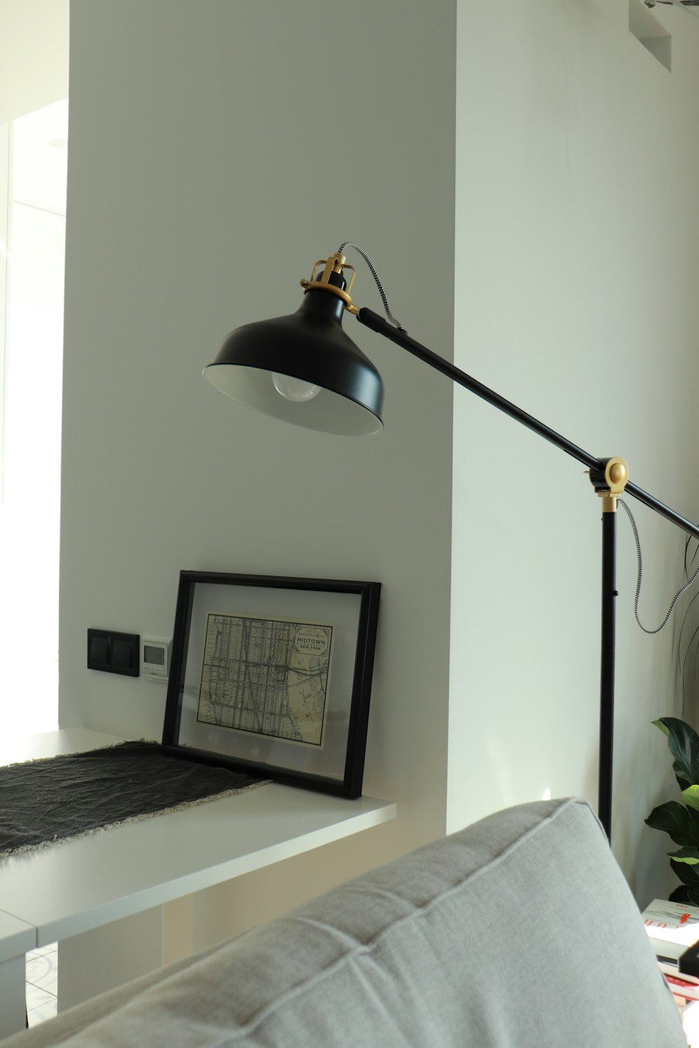 black floor lamp near white wall