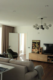black flat screen tv on brown wooden tv rack
