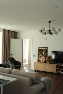 black flat screen tv on brown wooden tv rack