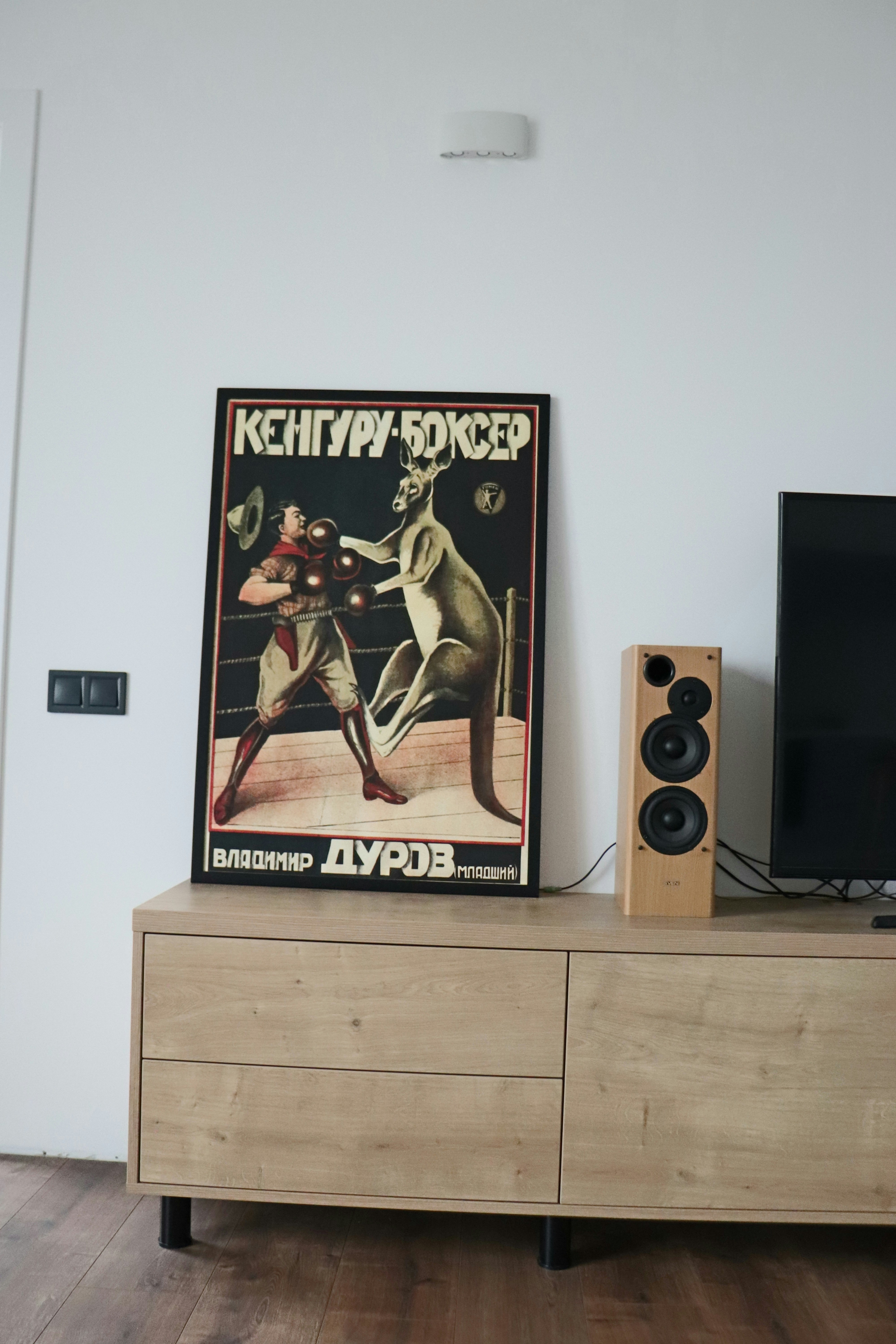 a poster on a dresser in a living room