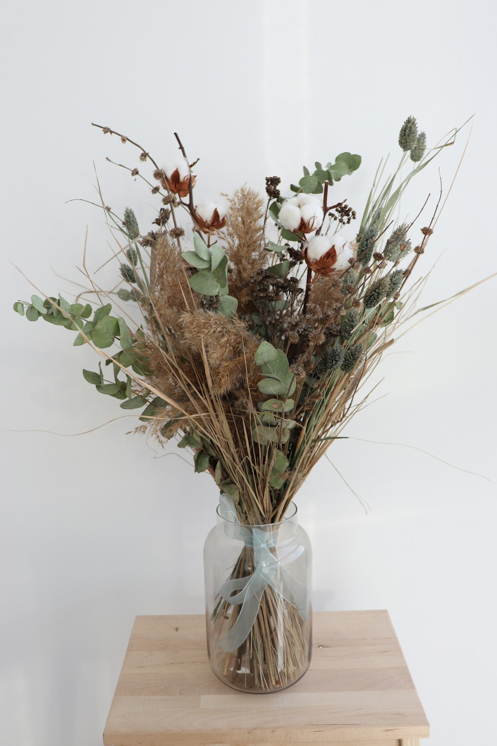 white and red flowers in clear glass vase