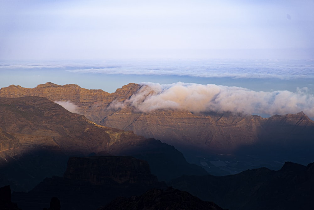 brown mountains under white clouds during daytime