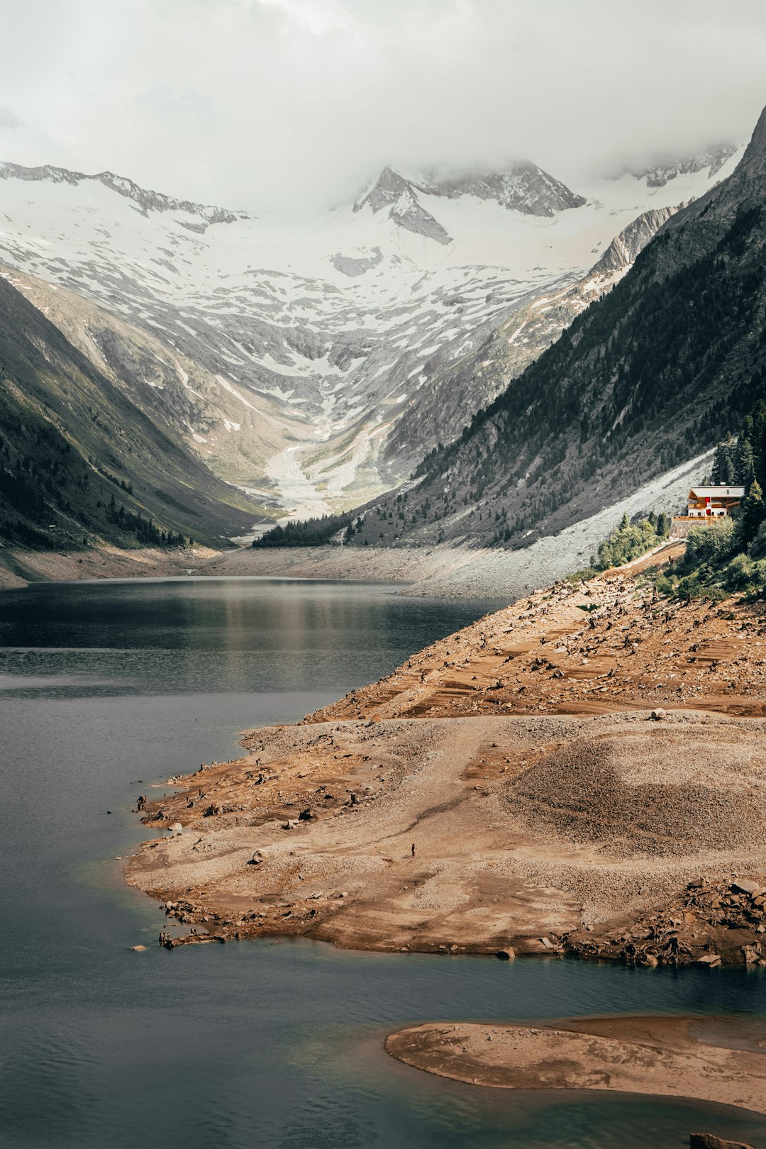 body of water near mountain during daytime