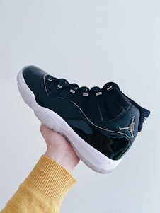 person wearing black nike running shoe