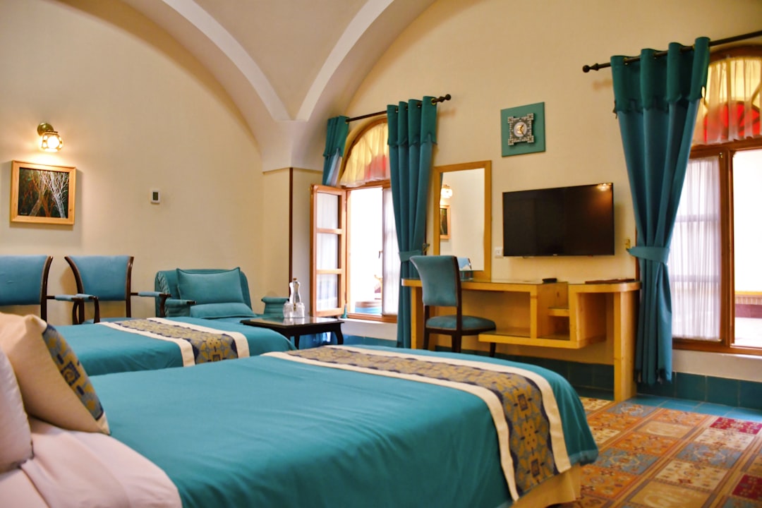 blue bed linen on bed, Feel the tranquility of travel in rooms and suites with Iranian architecture and modern and worldwide standard facilities<p></figure>Photo : @saharbashi