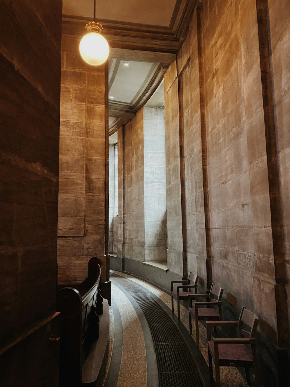 brown wooden chairs and table in hallway