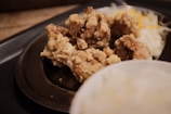A close-up of a plate featuring fried chicken and collard greens.