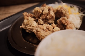 Close-up of a delicious plate of southern comfort food from a local Atlanta eatery, featuring fried chicken and collard greens.