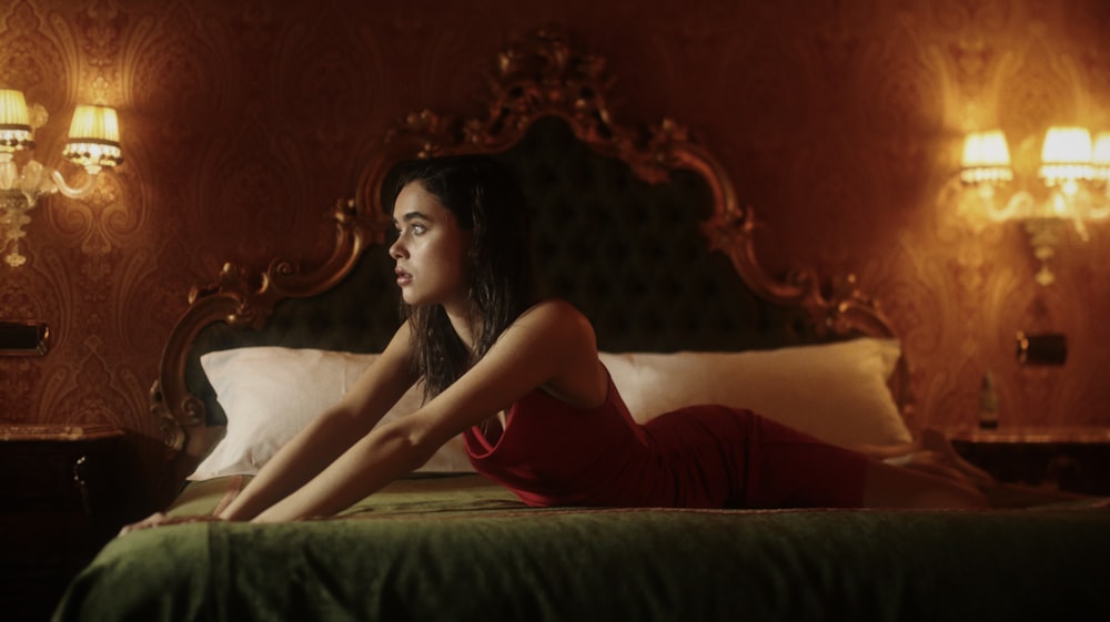 woman in red sleeveless dress lying on bed