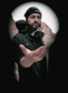 man in black jacket holding black camera