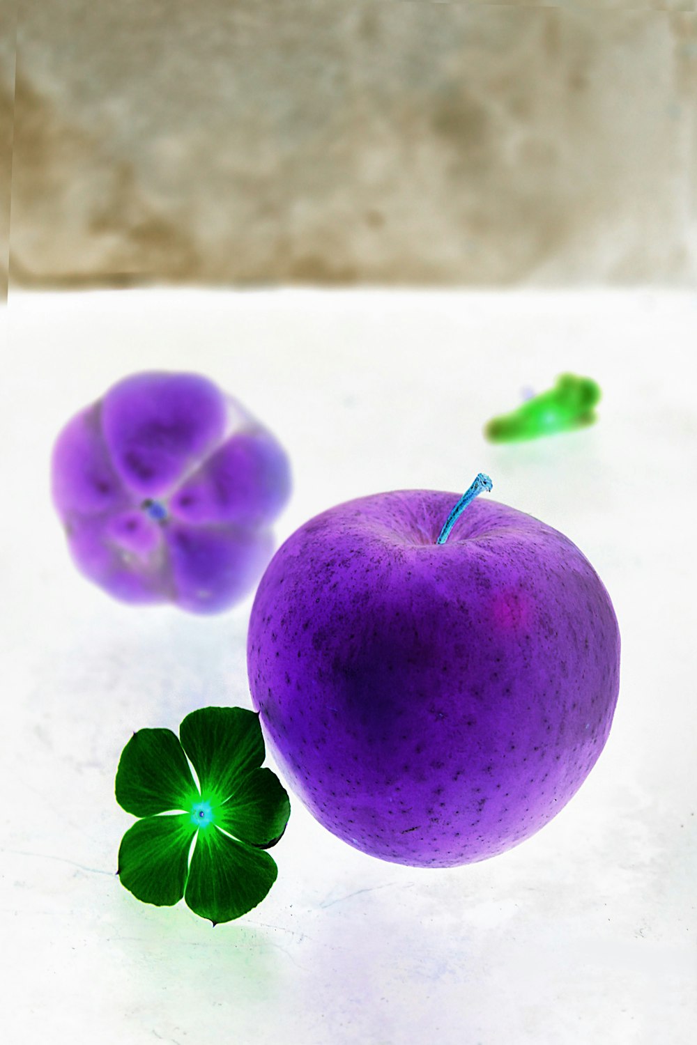 green apple fruit beside pink flower