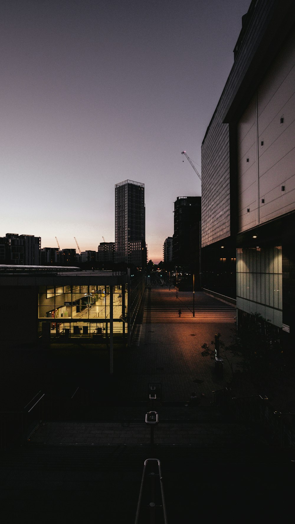 silhouette of person walking on sidewalk during sunset