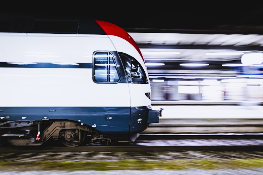 blue and white train on rail tracks