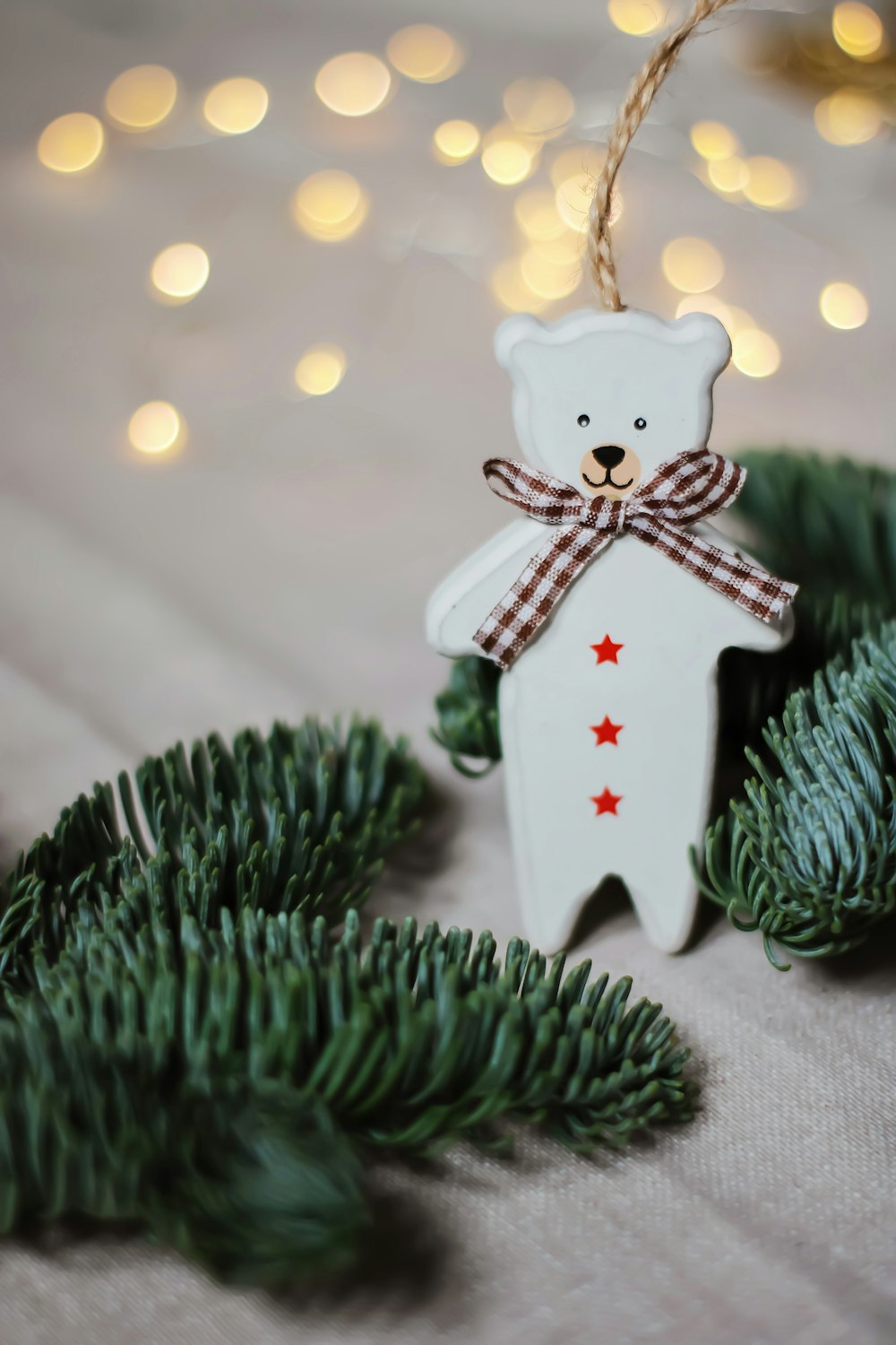 white angel christmas ornament on green pine tree