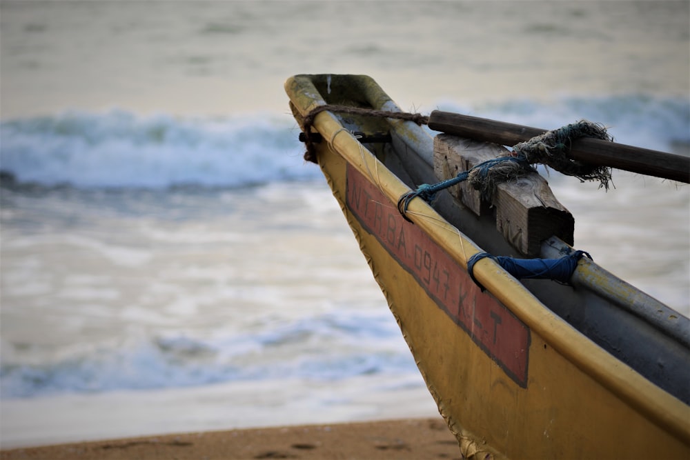 yellow and black boat on seashore during daytime