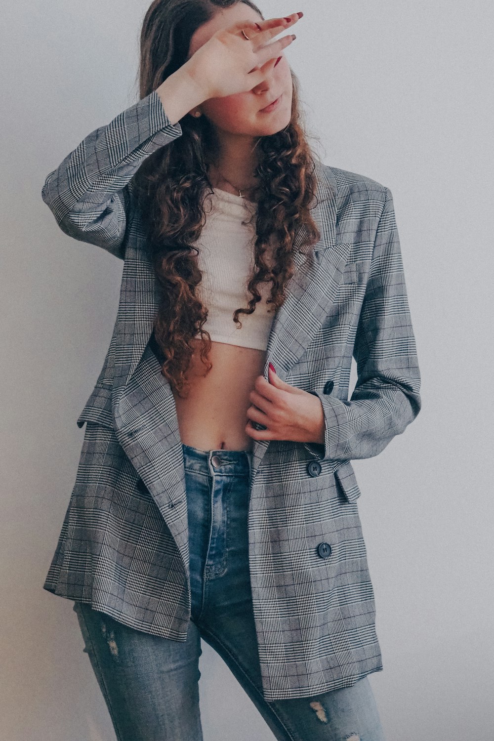 woman in gray coat and blue denim jeans