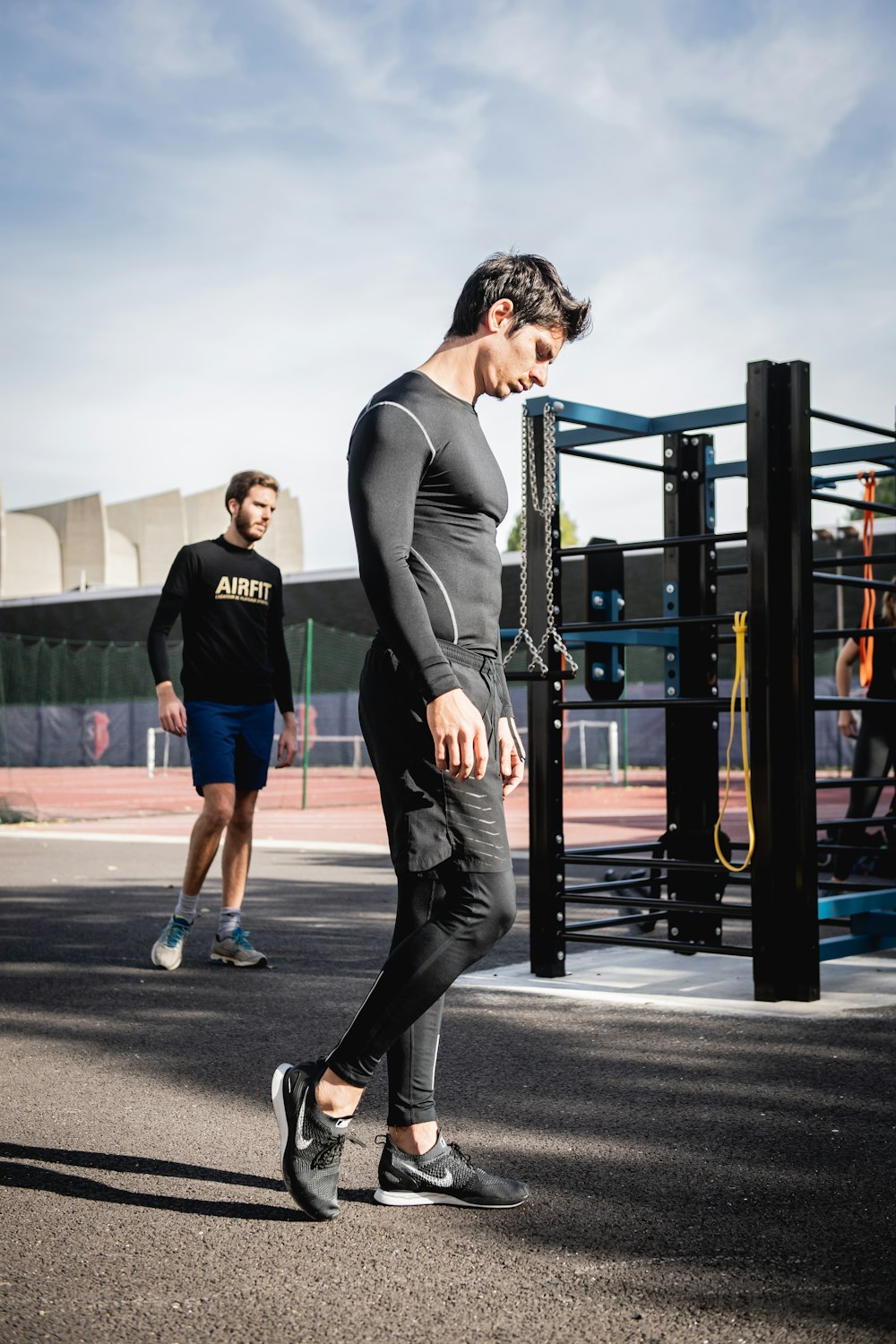 man in black long sleeve shirt and black pants running on road during daytime