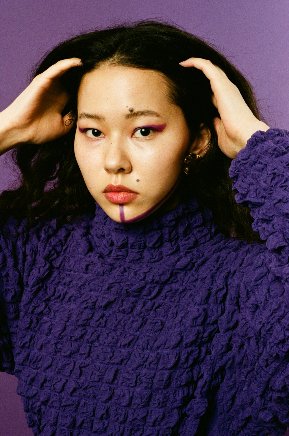 woman in purple knit turtle neck sweater