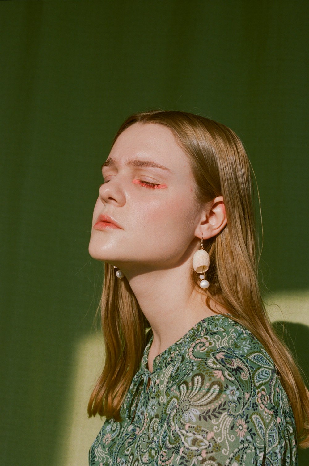 woman in green and white floral shirt