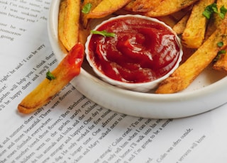 fries and red sauce on white ceramic plate