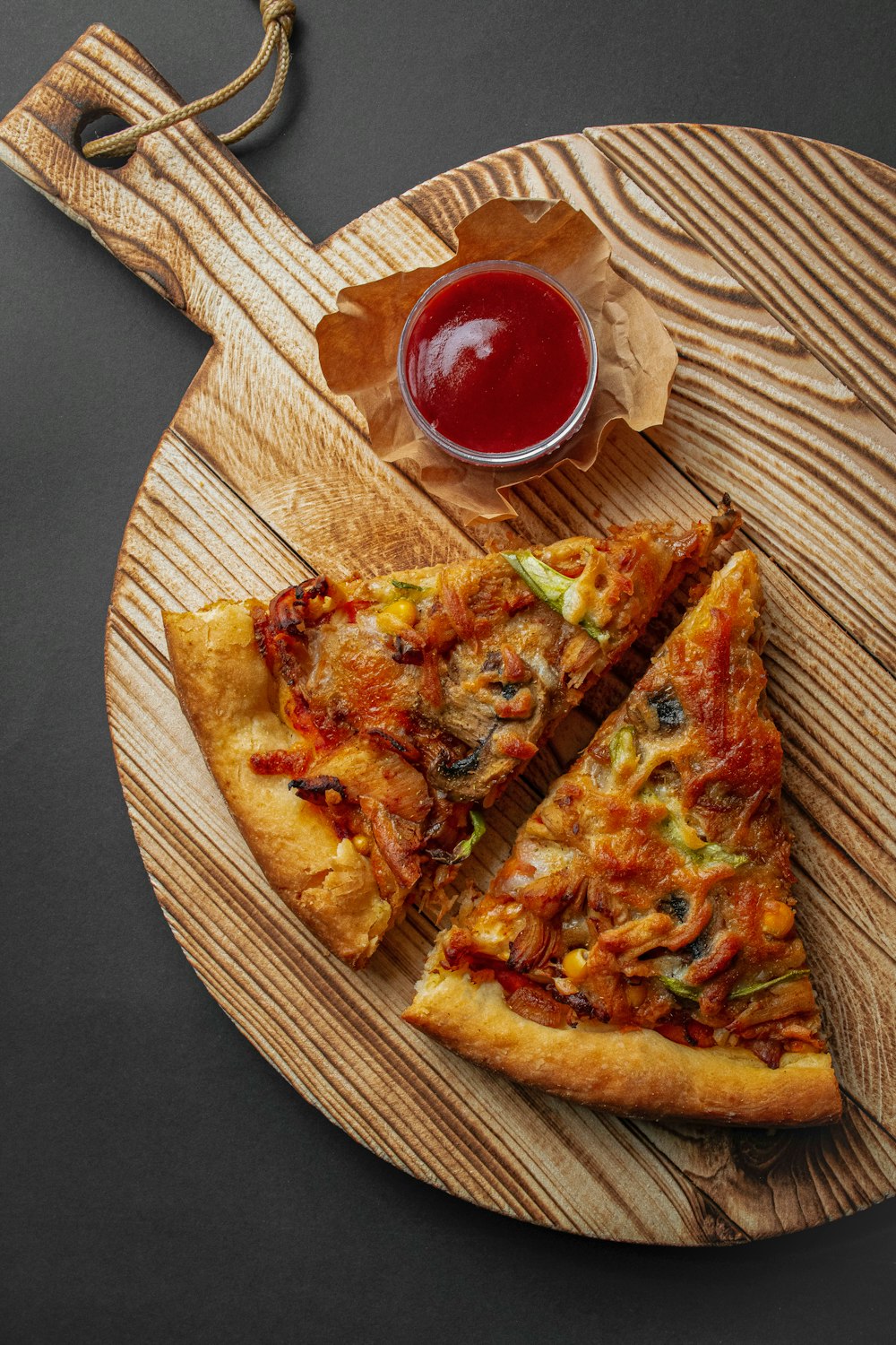 pizza with tomato sauce on brown wooden table