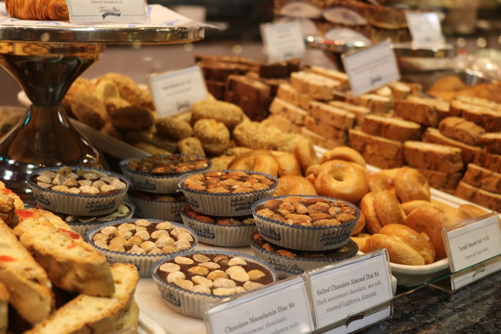 brown and white doughnuts on white wooden rack