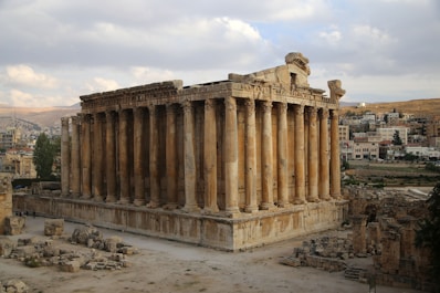 brown concrete building under white clouds during daytime