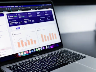 A laptop screen displaying a Google Ads dashboard with campaign metrics.