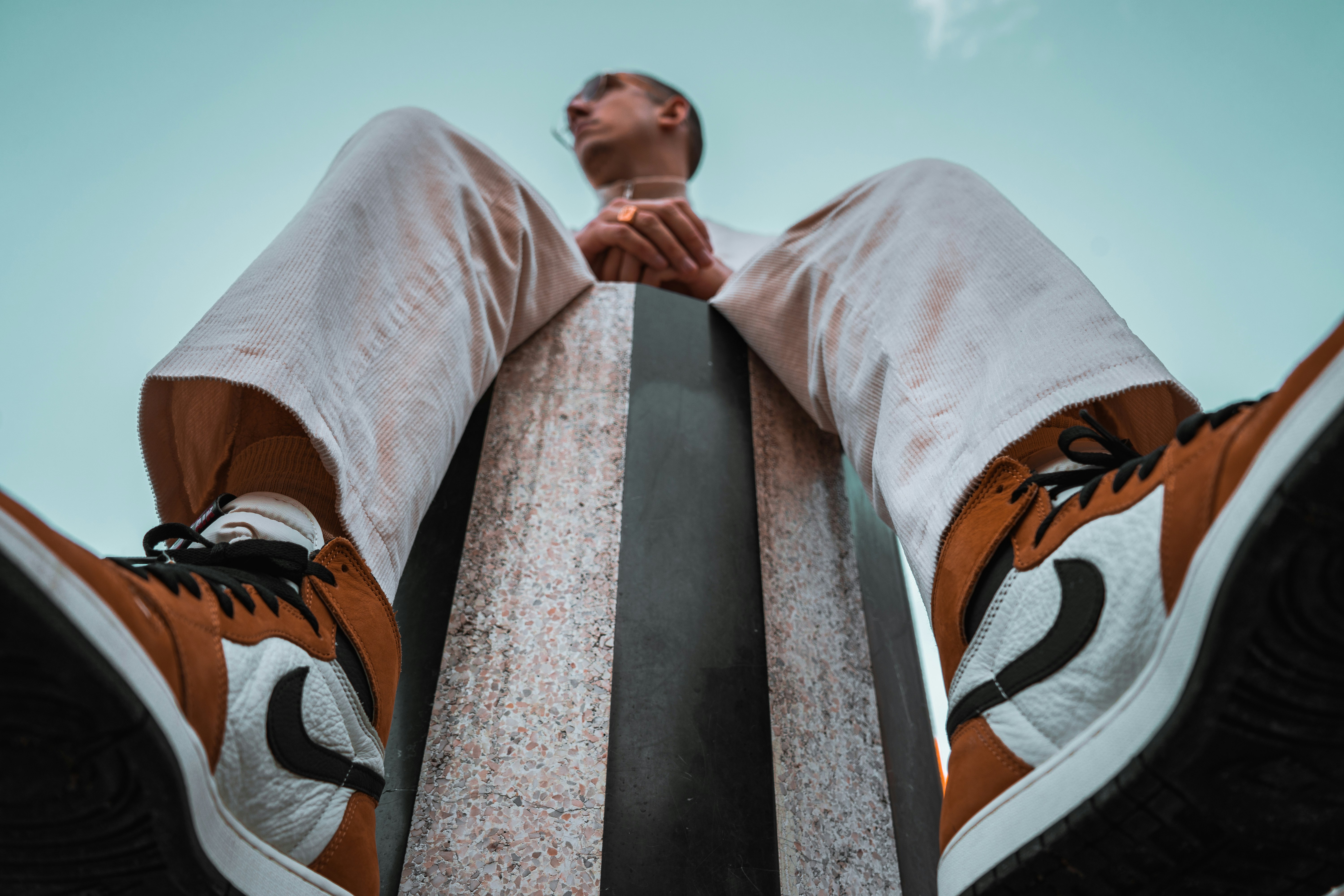 person in white orange and black pants