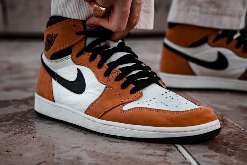 person wearing brown and white nike high top sneakers photo – Free Paris  Image on Unsplash
