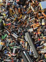 A battery recycling station with various types of batteries being processed.