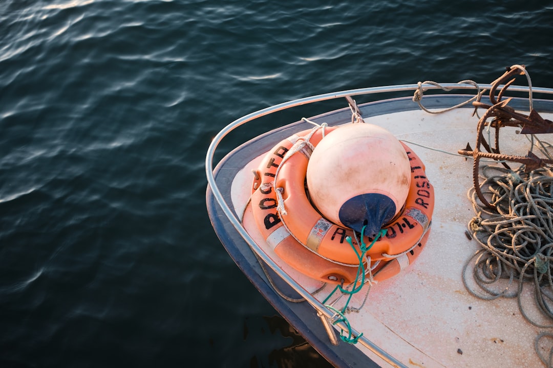 white and orange inflatable boat on blue sea during daytime