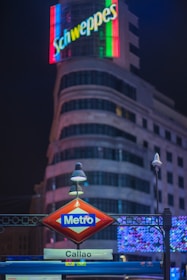 A vibrant illuminated backlight sign glowing at night on a busy Lima street.
