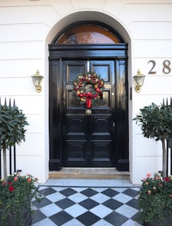 black wooden door with red flowers